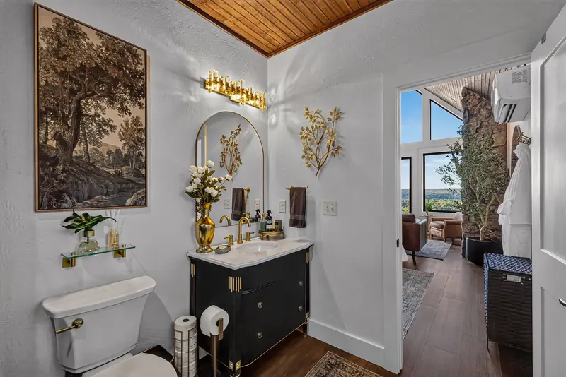 The vanity, artwork and a glimpse of the great room beyond