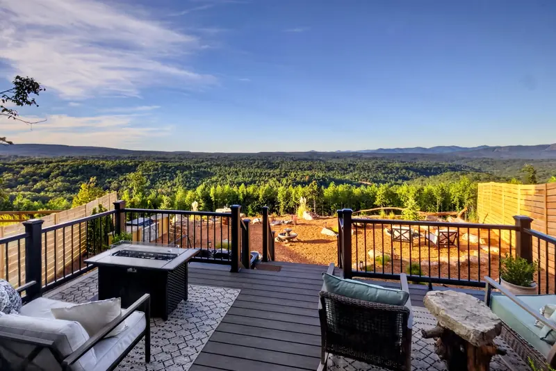 The fire table and lounge chairs on the deck by day