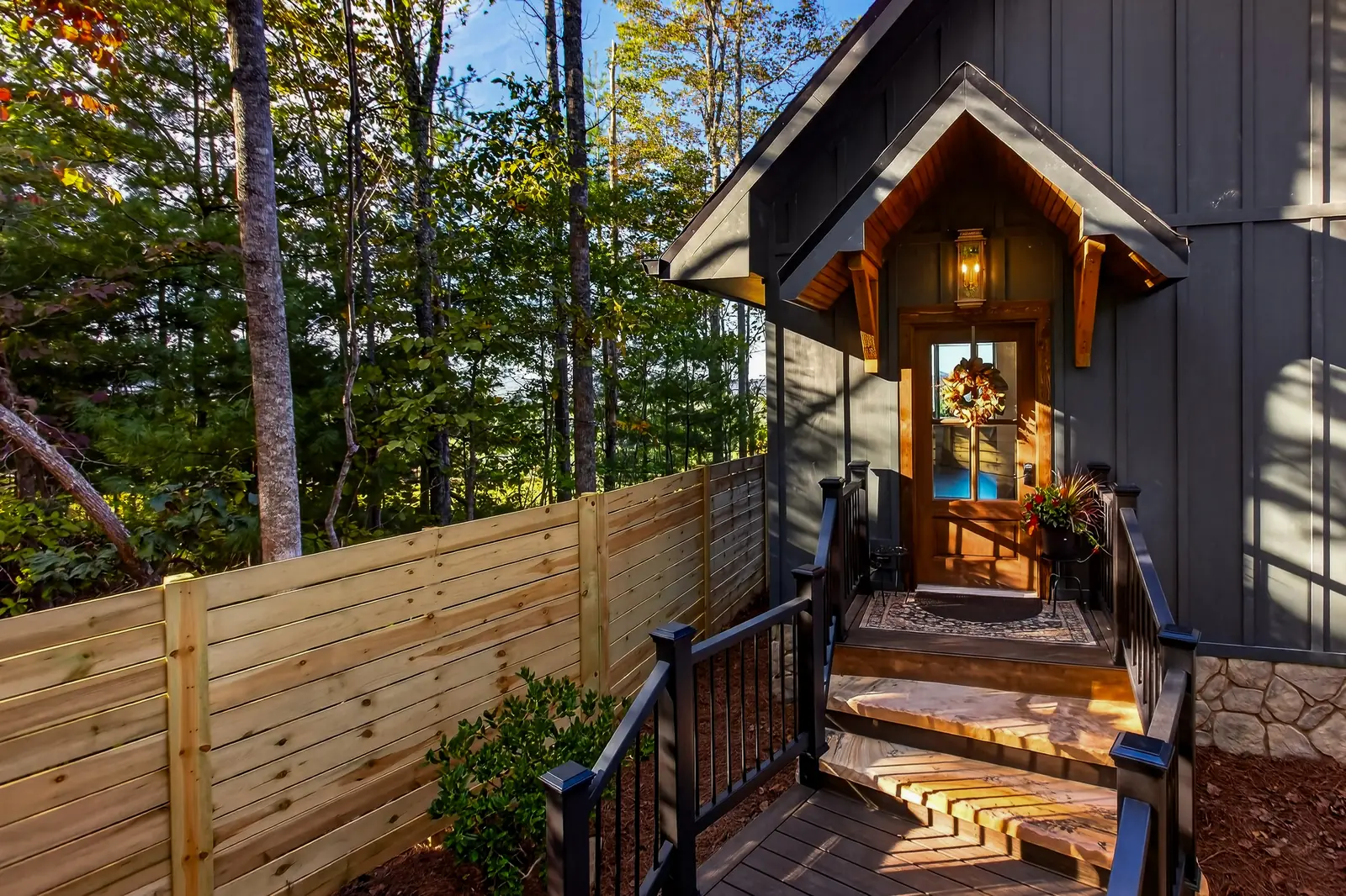 Bellora's private entrance: a lantern-lit wooden door beneath a timber gable, reached by stone steps
