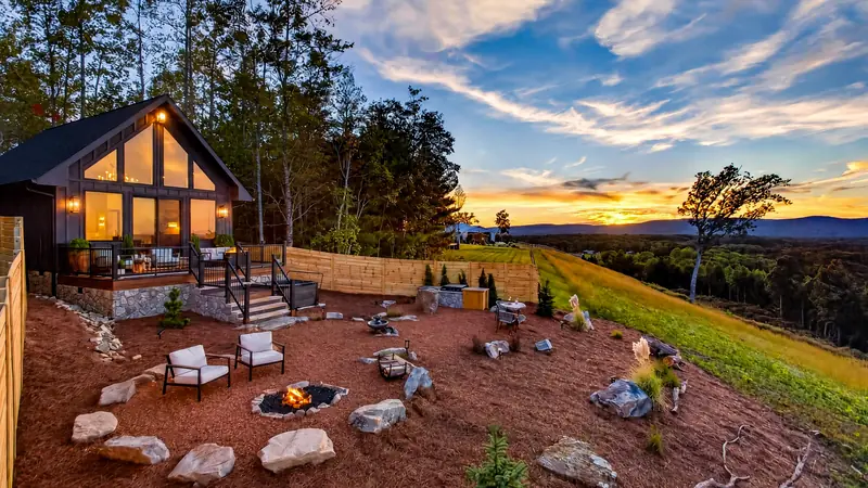 Bellora at sunset, the fire pit lit and the ridgeline glowing beyond
